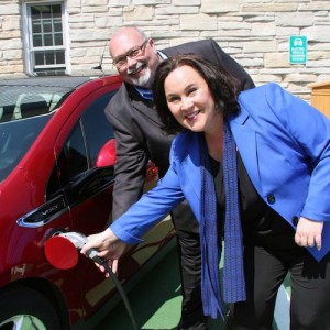 Jack Moneypenny, President/CEO of the DCVB, and Stephanie Klett, Secretary of Wisconsin Department of Tourism, plugging in the first car the DCVB charging station.