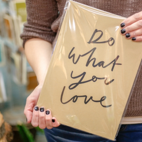 woman holding do what you love sign